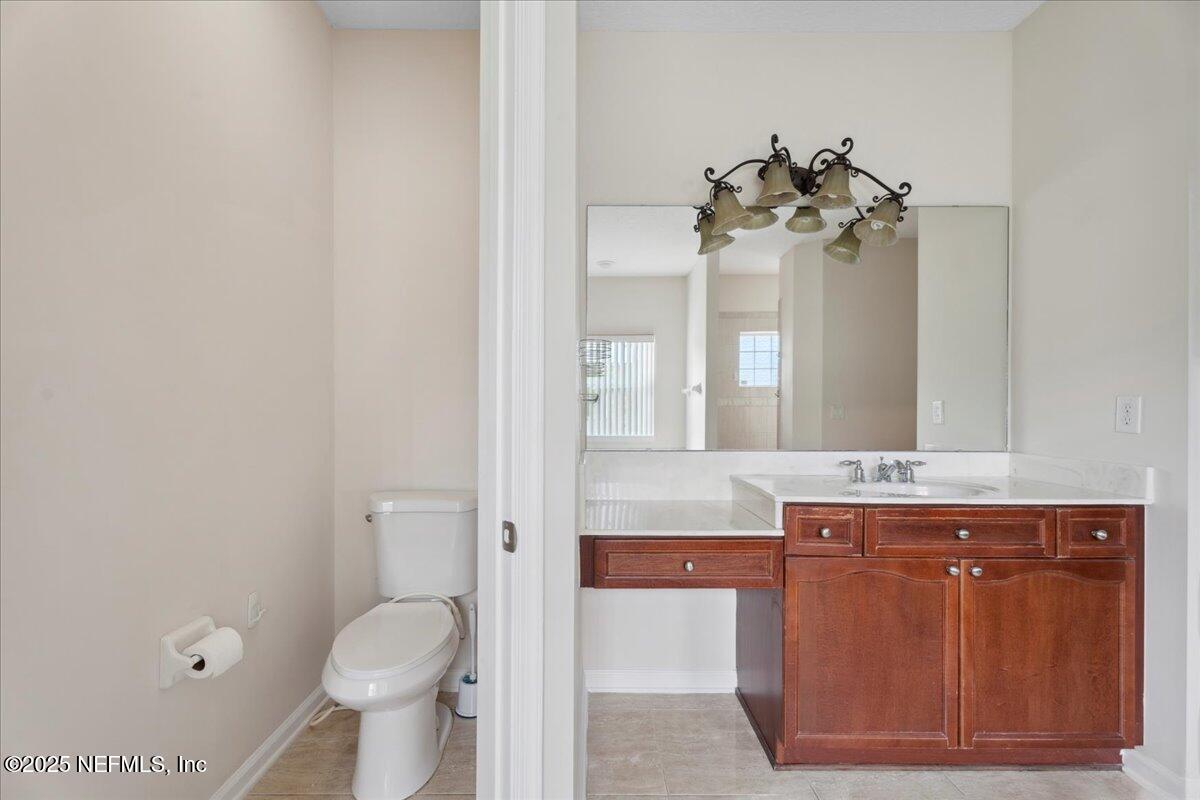 1127 Emilys Walk Lane West Jacksonville, FL 32221 - Photo 28 of 43 a bathroom with a sink a toilet and a mirror