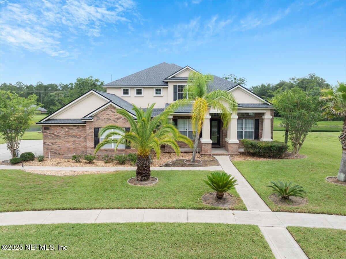 1127 Emilys Walk Lane West Jacksonville, FL 32221 - Photo 35 of 43 a front view of a house with a yard and garage