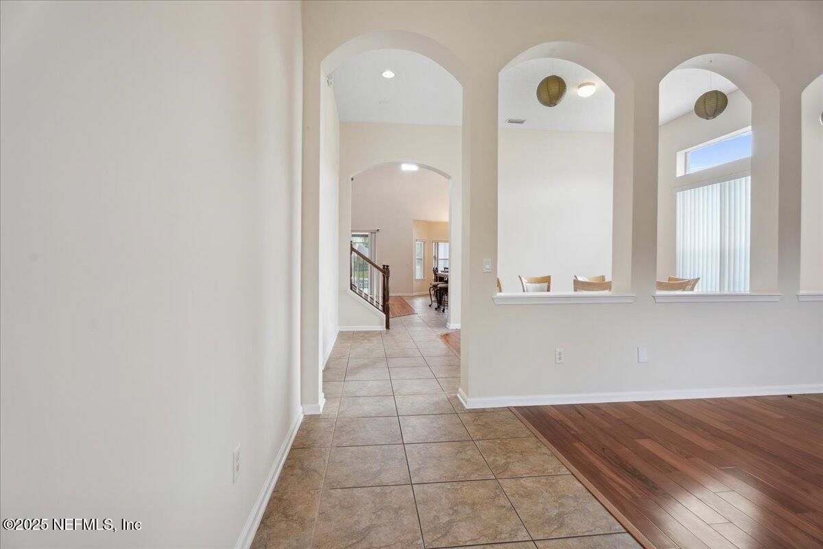 1127 Emilys Walk Lane West Jacksonville, FL 32221 - Photo 6 of 43 a view of a hallway with wooden floor and a large mirror