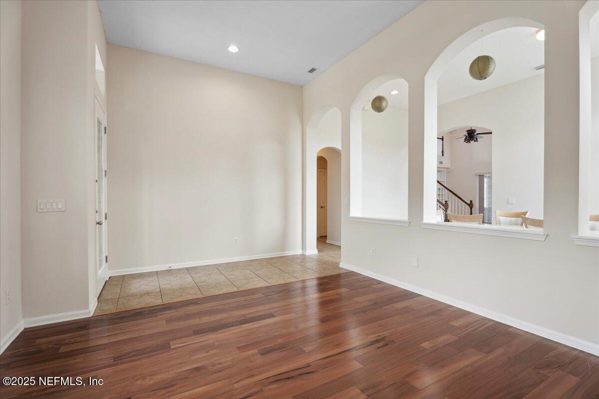 1127 Emilys Walk Lane West Jacksonville, FL 32221 - Photo 7 of 43 a view of an empty room with wooden floor and a window