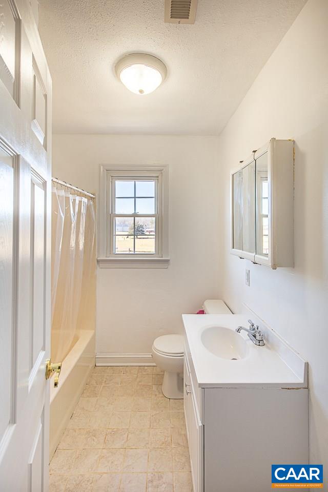 8031 Howardsville Road Howardsville, VA 24562 - Photo 21 of 30 a bathroom with a sink a toilet and shower