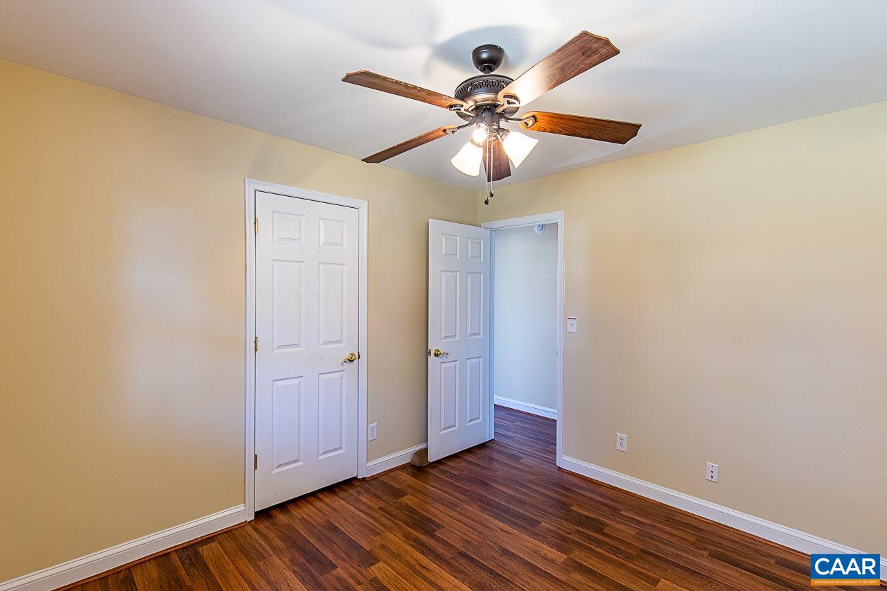 8031 Howardsville Road Howardsville, VA 24562 - Photo 23 of 30 an empty room with wooden floor fan and windows