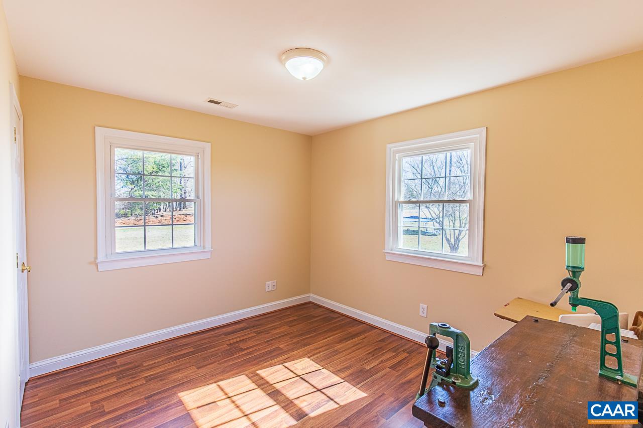 8031 Howardsville Road Howardsville, VA 24562 - Photo 24 of 30 a view of an empty room with wooden floor and a window