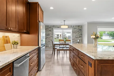 a large kitchen with stainless steel appliances lots of counter top space