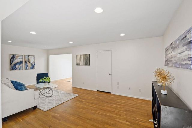 a living room with furniture and large window