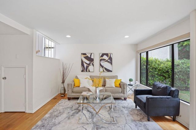 a kitchen with stainless steel appliances granite countertop a refrigerator a sink a stove and cabinets