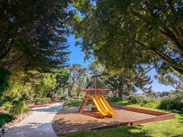 a view of a chairs and table in the backyard