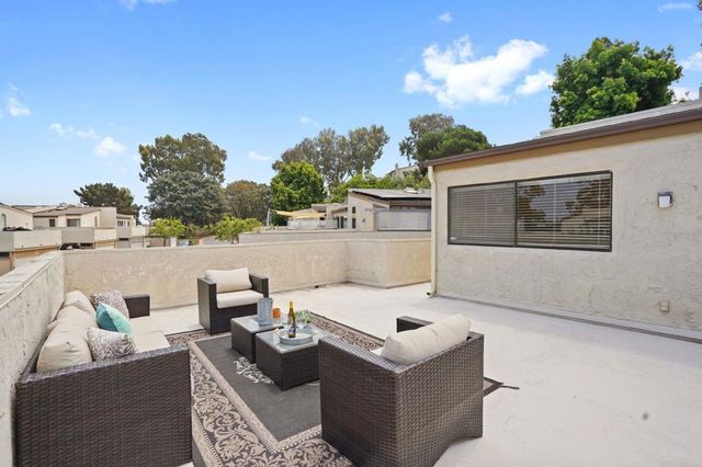 a view of a patio with table and chairs and potted plants