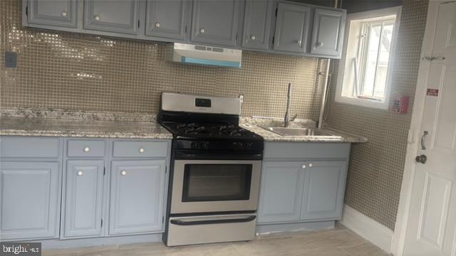 5630 Walnut Street, Unit 2 Philadelphia, PA 19139 - Photo 16 of 28 a kitchen with granite countertop white cabinets and stainless steel appliances