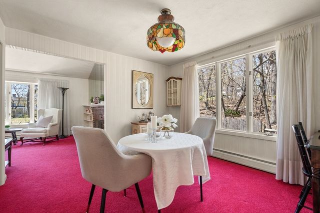 a view of a dining room with furniture and a large window