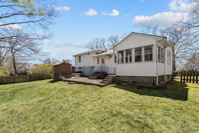 a view of a house with swimming pool and sitting area