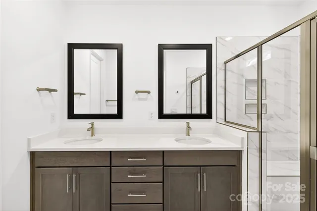 a bathroom with 2 sink and a mirror