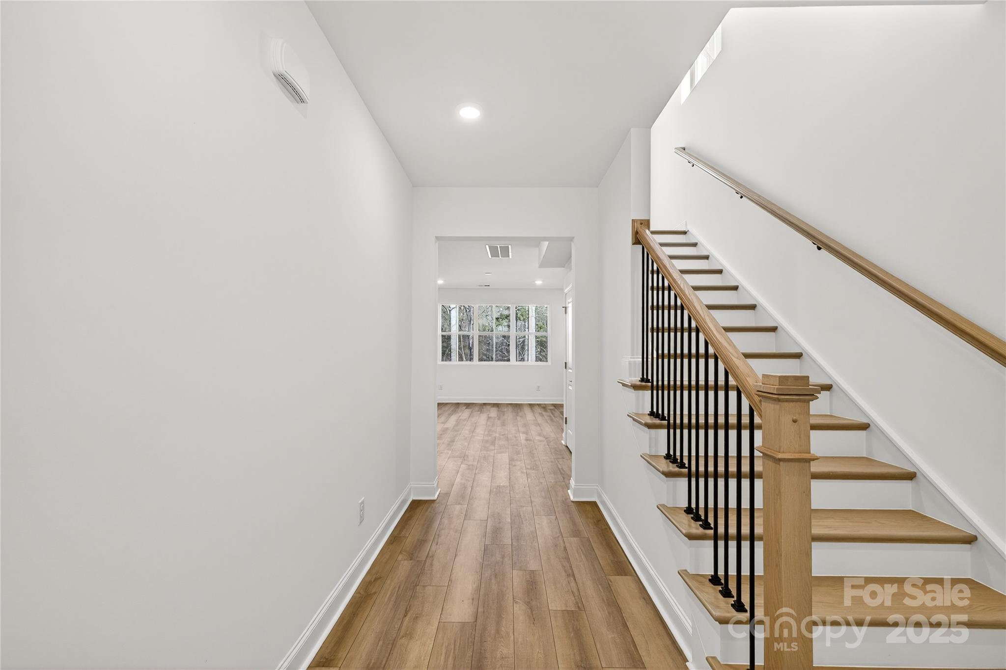 520 Zinc Drive Tega Cay, SC 29708 - Photo 2 of 20 a view of a hallway with wooden floor and entryway
