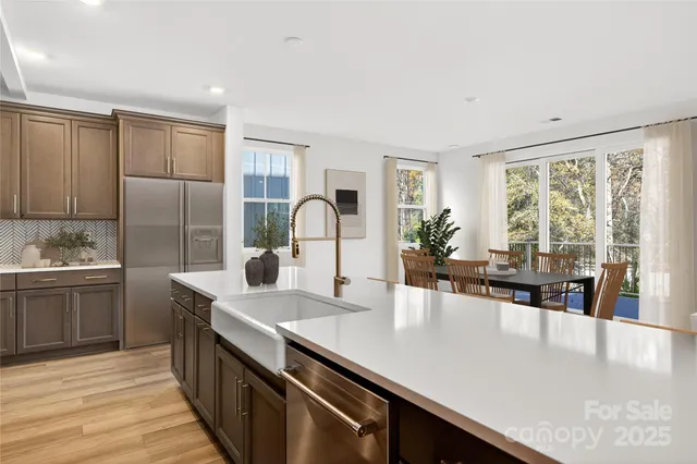 a kitchen with kitchen island a sink appliances and a counter space