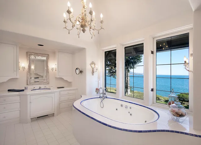 a bathroom with a tub sink and mirror