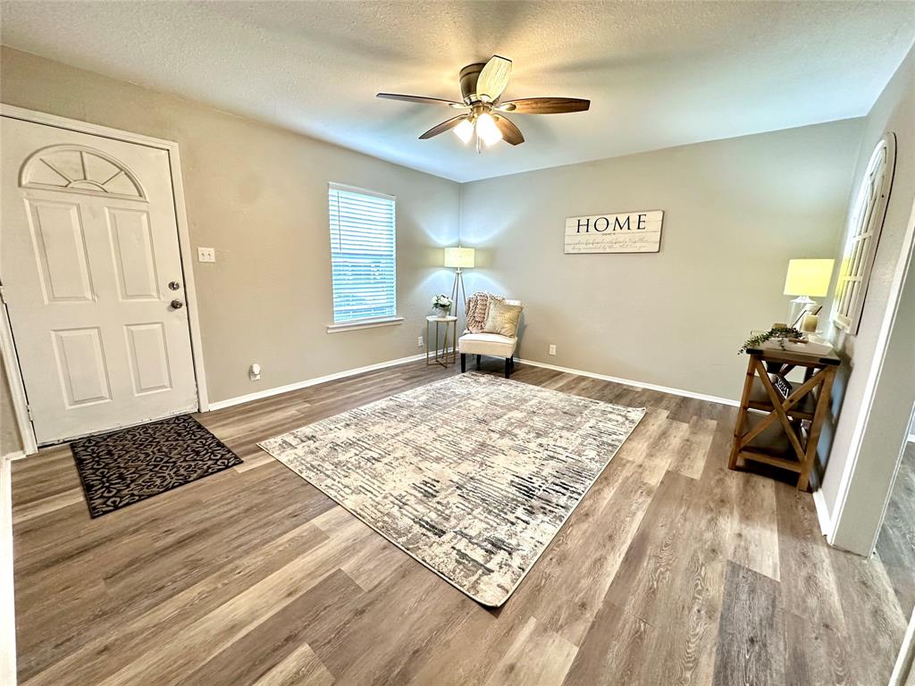 504 Bales Street Cleburne, TX 76033 - Photo 2 of 11 a bedroom with a bed and a chandelier