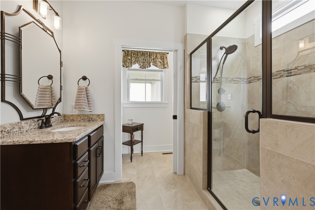25181 West Soap Stone Road Jetersville, VA 23083 - Photo 23 of 54 Bathroom featuring a dark wood vanity with a grani