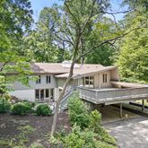 a view of a house with a yard deck and furniture