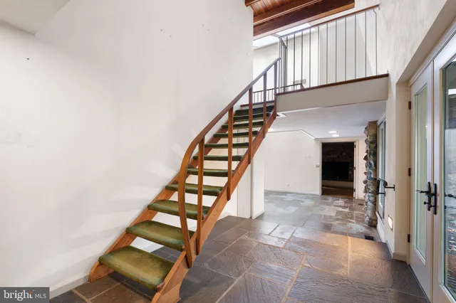 a view of a balcony with wooden floor and furniture