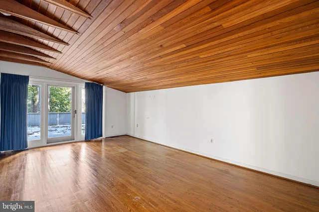 an empty room with wooden floor