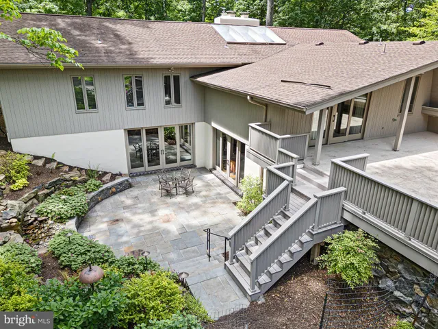 a aerial view of a house with a yard and sitting area