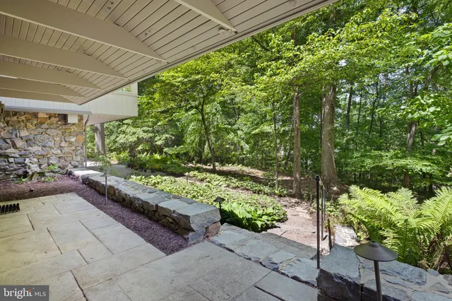 a outdoor sitting area with couch and glass door