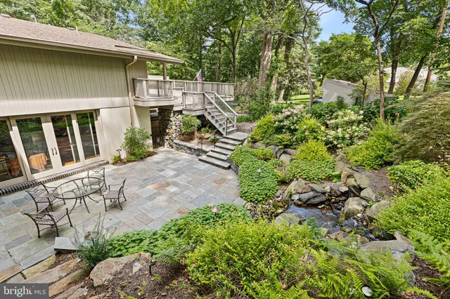 a view of a house with a small yard and wooden fence