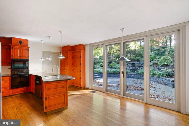 an empty room with wooden floor and sliding door