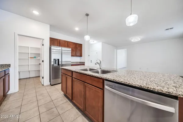 a kitchen with stainless steel appliances granite countertop a sink and a stove