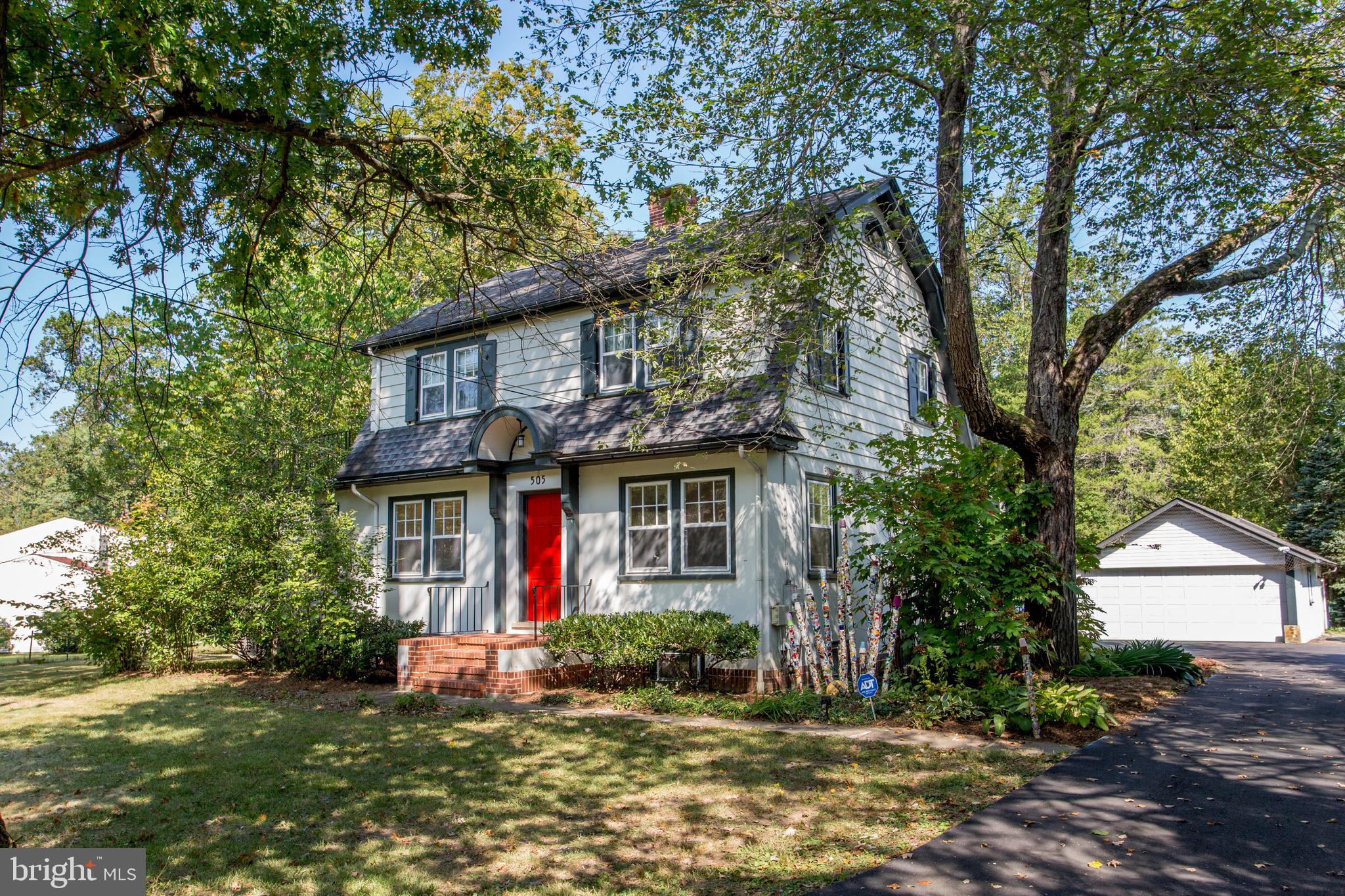 a view of a house with a tree in front