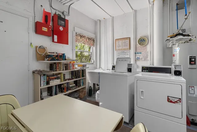 a room with furniture a washer and a large window