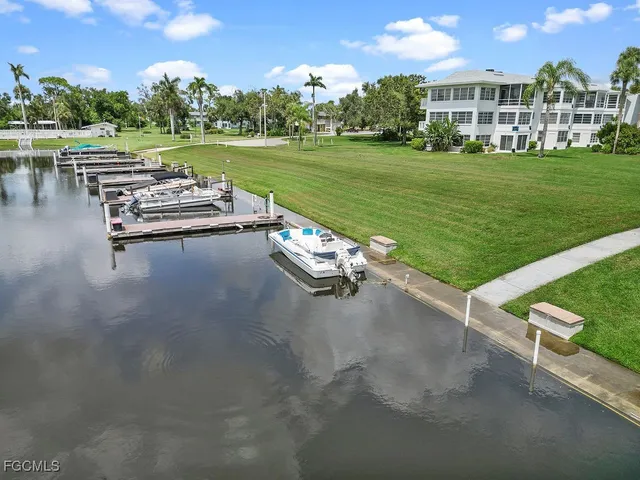 a view of a patio with lawn chairs wooden floor and lake view