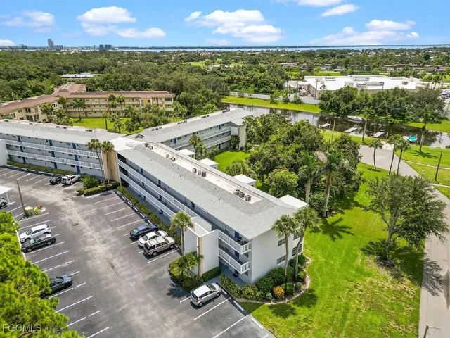 an aerial view of a house with a garden and lake view