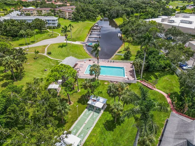 an aerial view of a house with outdoor space pool seating area and yard