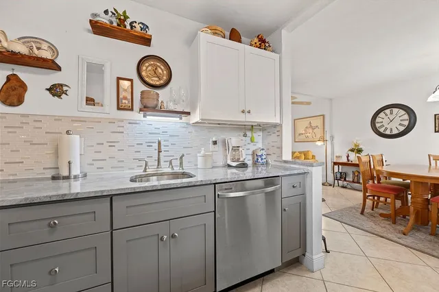 a kitchen with a sink and a clock on the wall