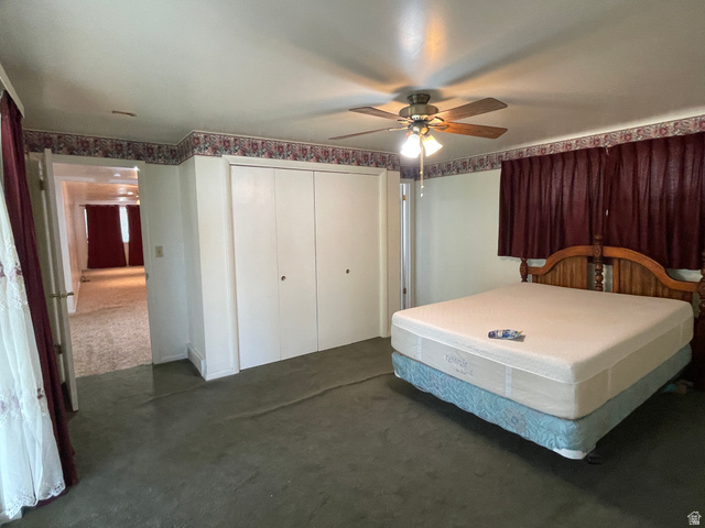 438 East Main Street Elsinore, UT 84724 - Photo 26 of 43 Carpeted room featuring a ceiling fan with integrated lighting, full-height double door closet, and an ornate wood headboard