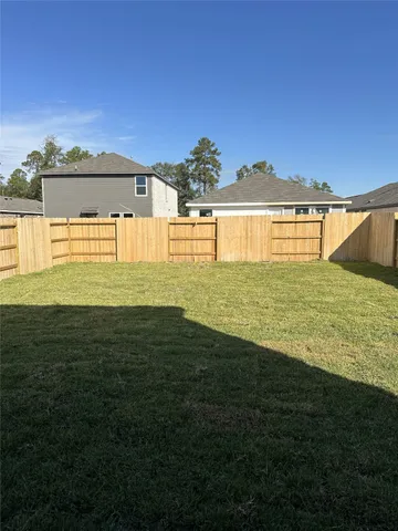 a view of a large pool with an outdoor space and seating area