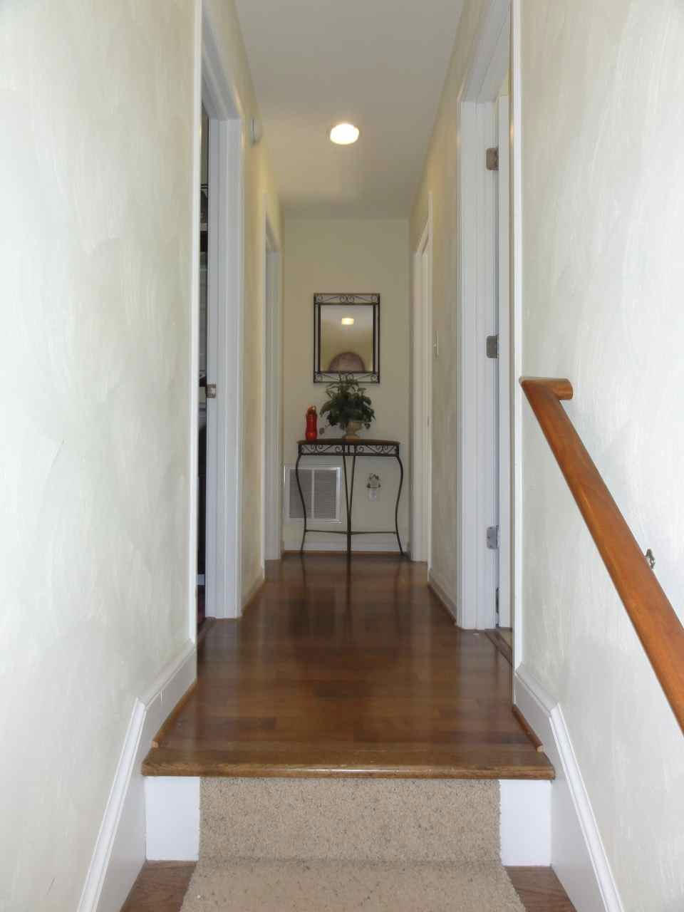 584 Zimmerman Road Blue Ridge, VA 24064 - Photo 14 of 33 a hallway with wooden floor electronic appliances and stairs