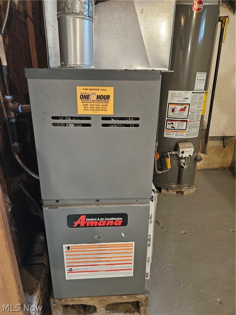 753 West River Road North Elyria, OH 44035 - Photo 21 of 28 Amana heating and air conditioning unit with an adjacent Rheem water heater