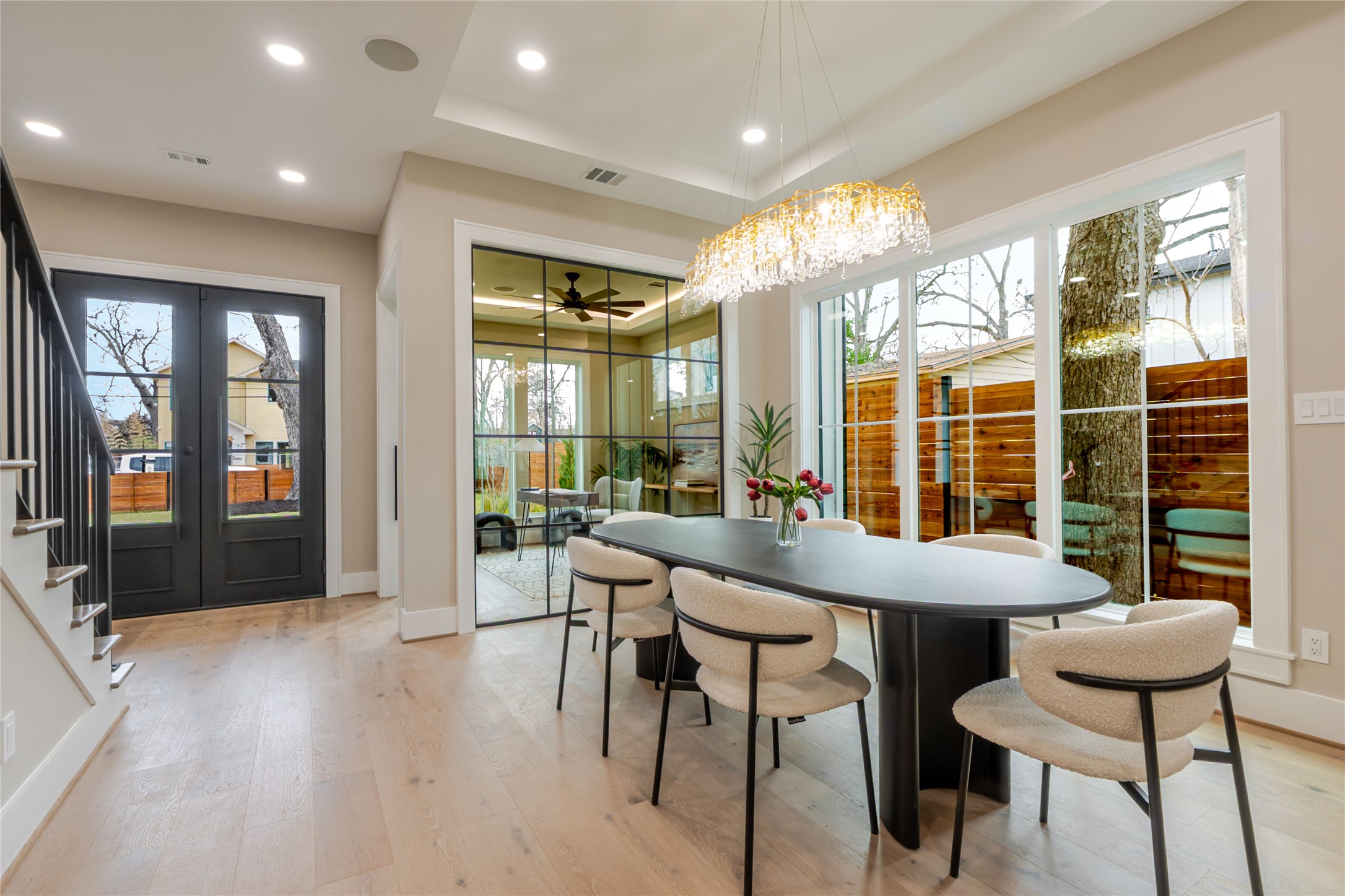 3100 Garwood Street Austin, TX 78702 - Photo 7 of 25 Dining space with a tray ceiling, light wood-style flooring, french doors, recessed lighting, and ceiling fan
