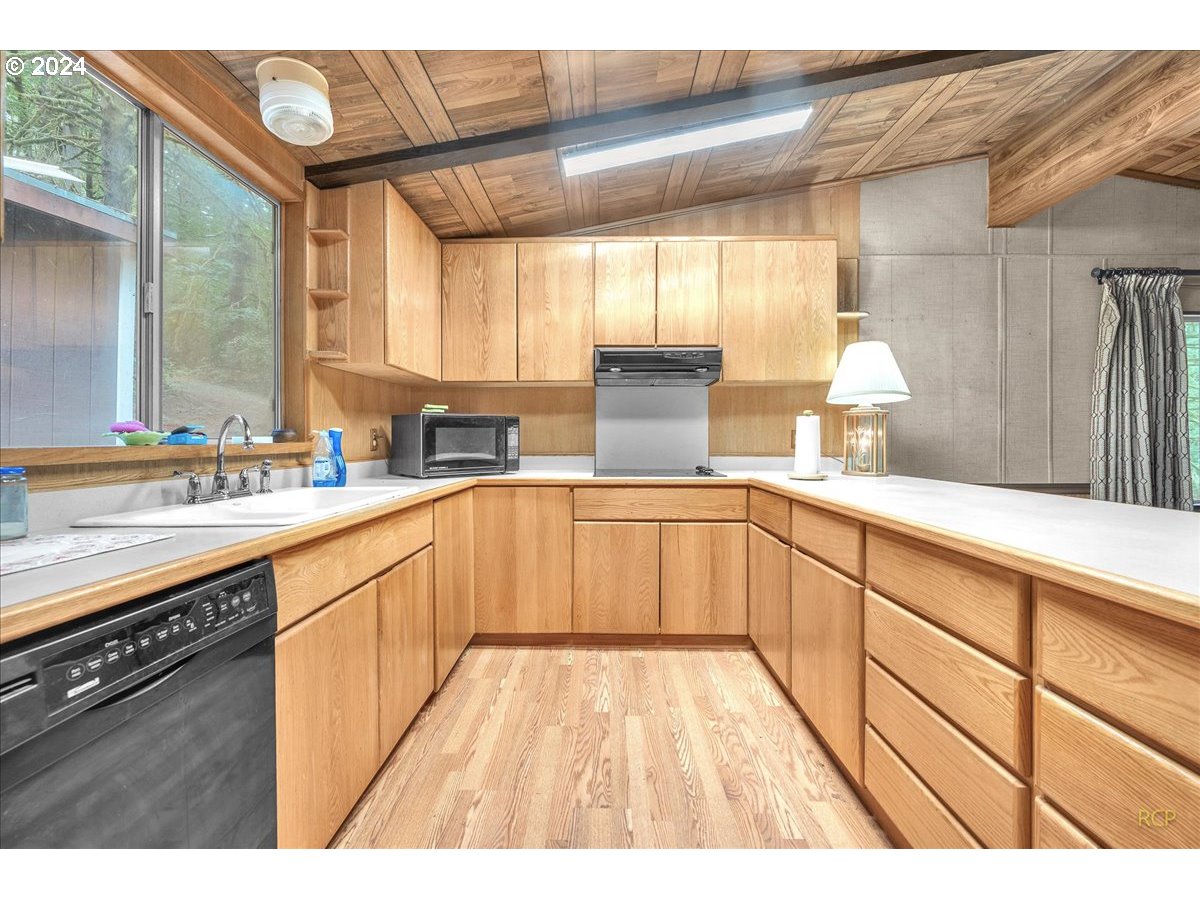 56925 Walker Road Scappoose, OR 97056 - Photo 11 of 40 a kitchen with a sink stove and cabinets