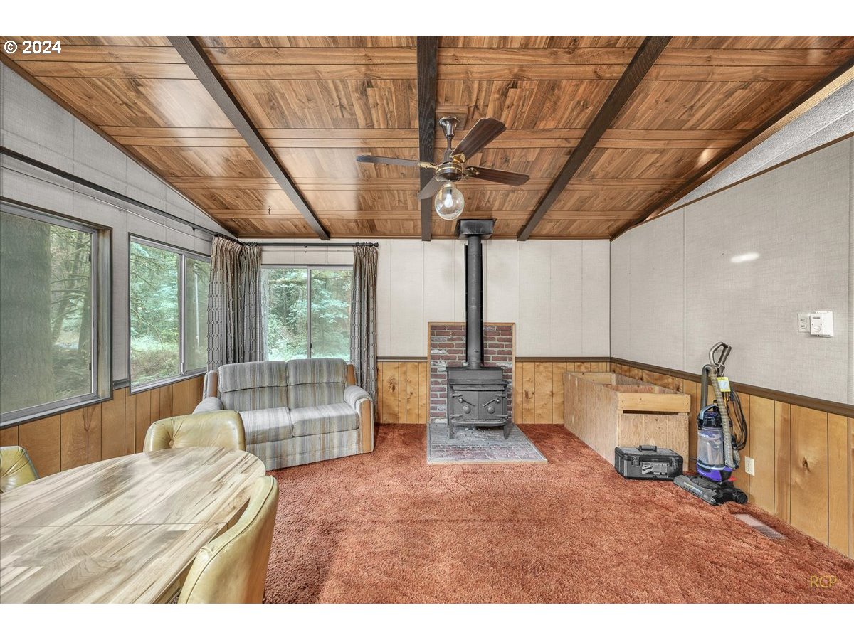 56925 Walker Road Scappoose, OR 97056 - Photo 14 of 40 a bedroom with furniture and large windows