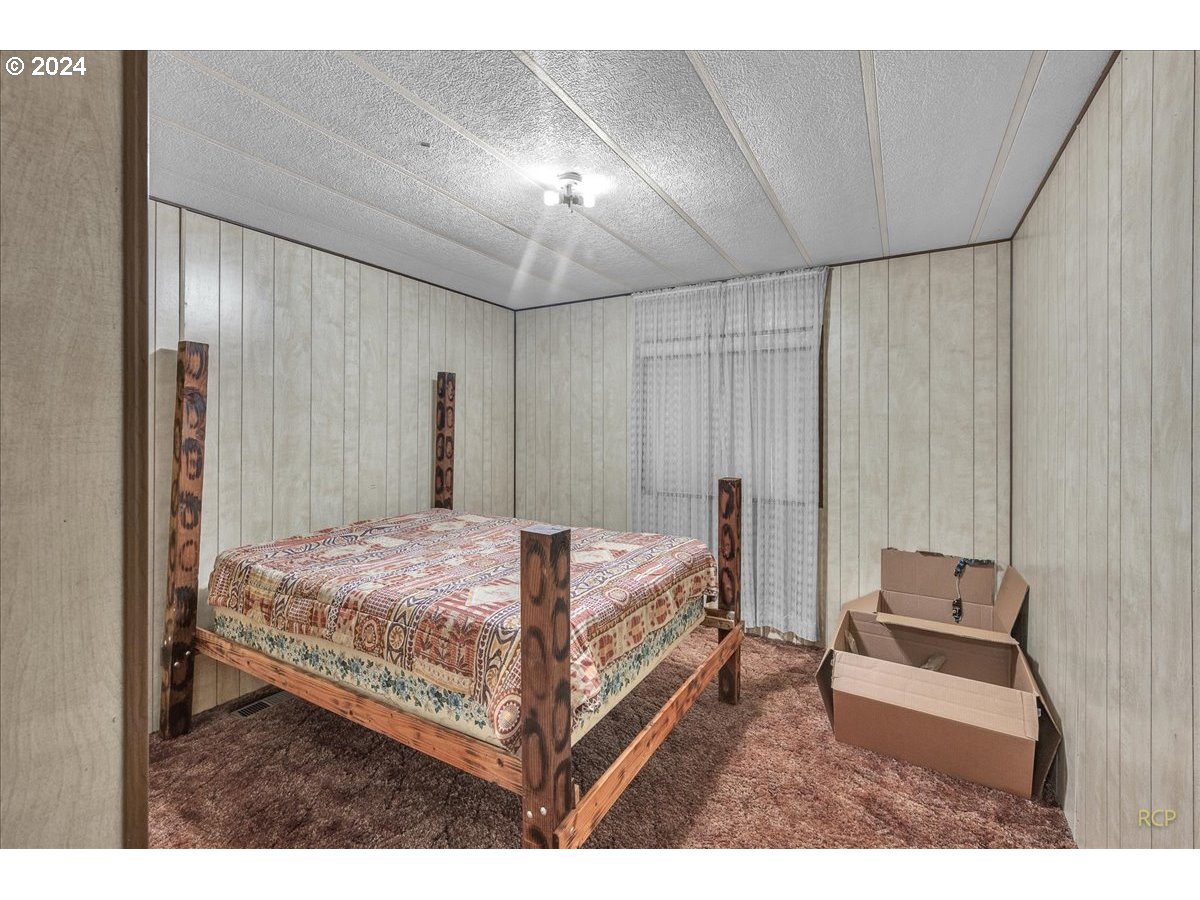 56925 Walker Road Scappoose, OR 97056 - Photo 18 of 40 a bed room with a bed and a couch