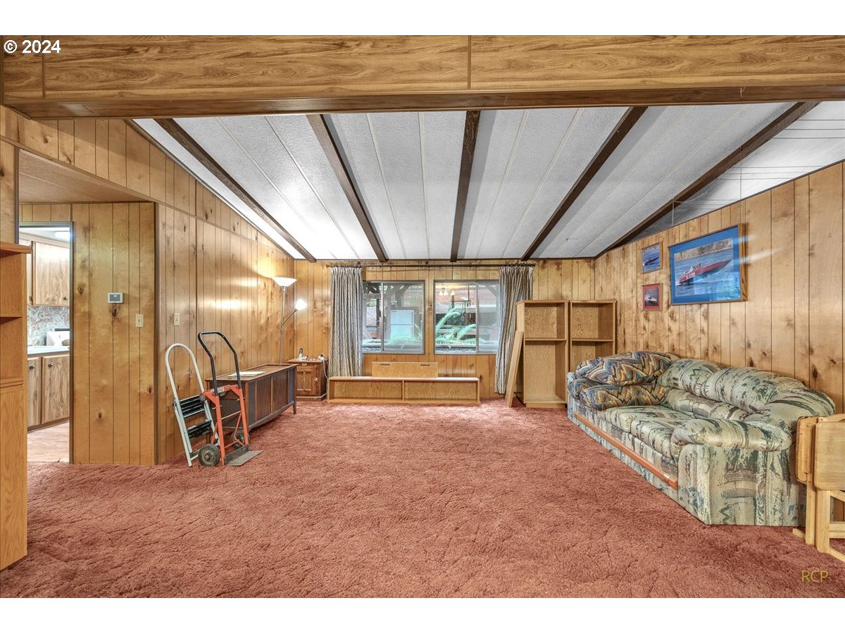 56925 Walker Road Scappoose, OR 97056 - Photo 9 of 40 a living room with furniture a flat screen tv and a large window