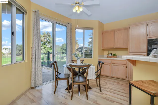 a dining room with furniture and a window