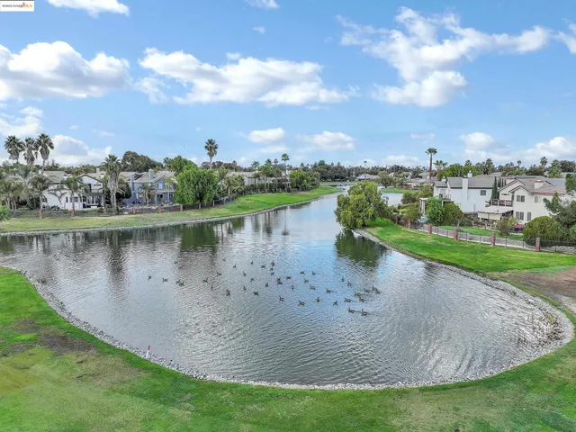 a view of a lake with houses in the back
