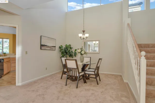a view of a dining room with furniture and chandelier