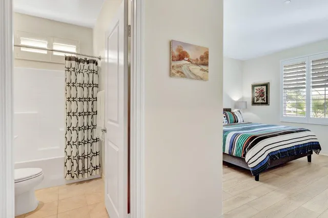 a bedroom with bed and a window