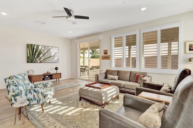 a living room with furniture and large windows