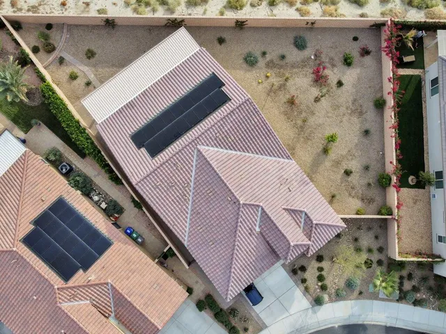 a view of a house with swimming pool and sitting area